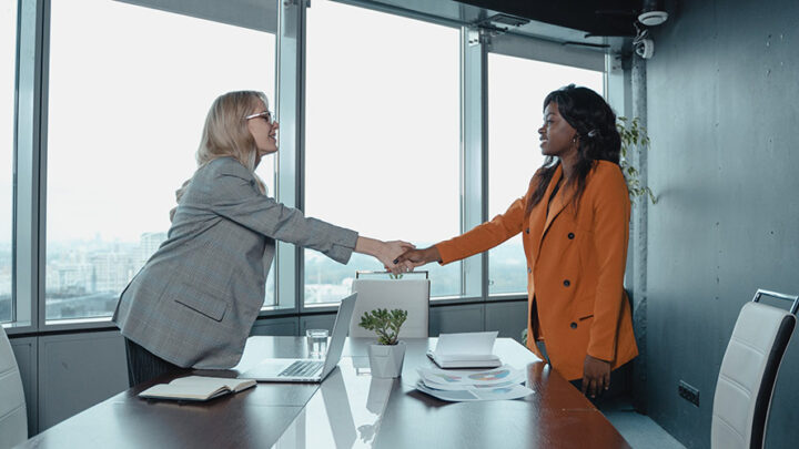 two people shaking hands and working together